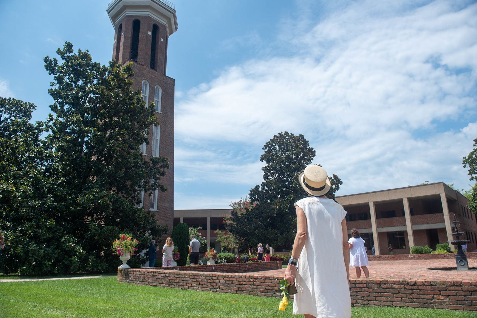 Woman stands outside facing the Bell Tower